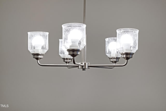 interior details featuring an inviting chandelier