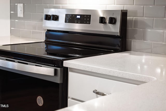kitchen with decorative backsplash and stainless steel electric range
