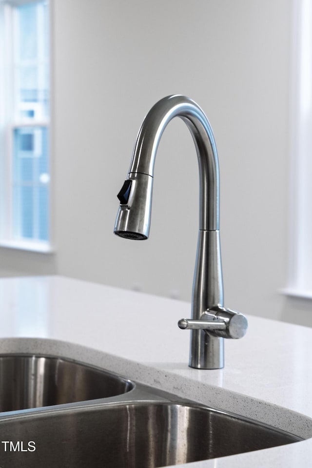 room details with light stone counters and sink