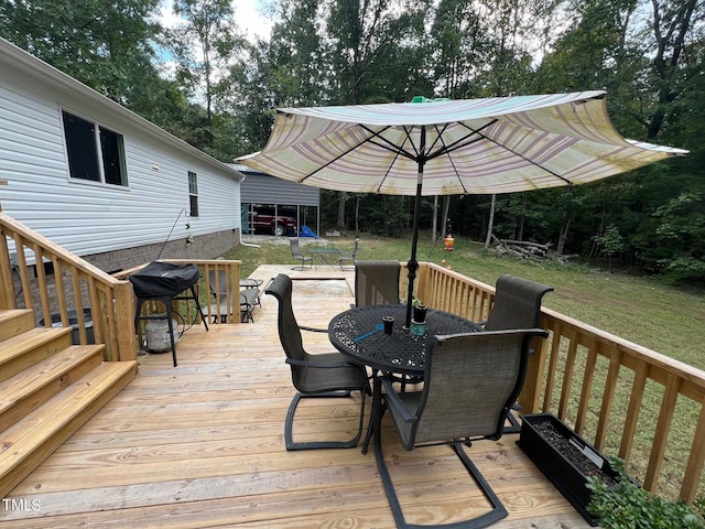 wooden terrace featuring a yard