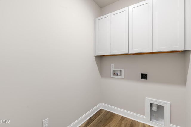 washroom featuring cabinets, washer hookup, dark wood-type flooring, and electric dryer hookup