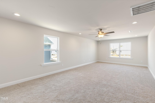 unfurnished room featuring carpet flooring, a wealth of natural light, and ceiling fan