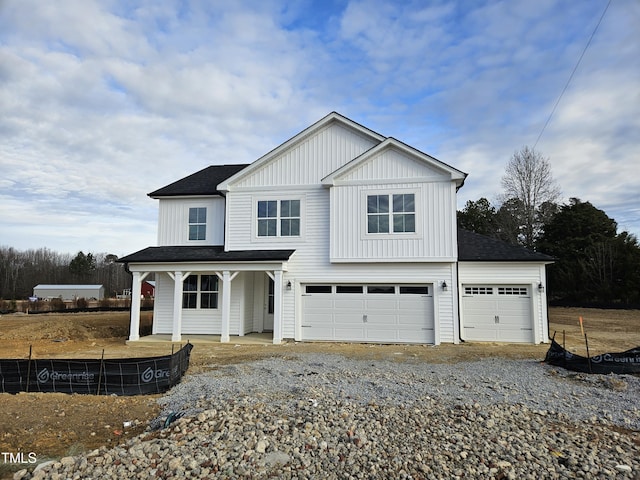 view of front of property featuring a porch and a garage