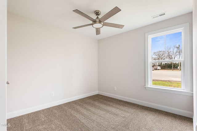 carpeted empty room featuring ceiling fan