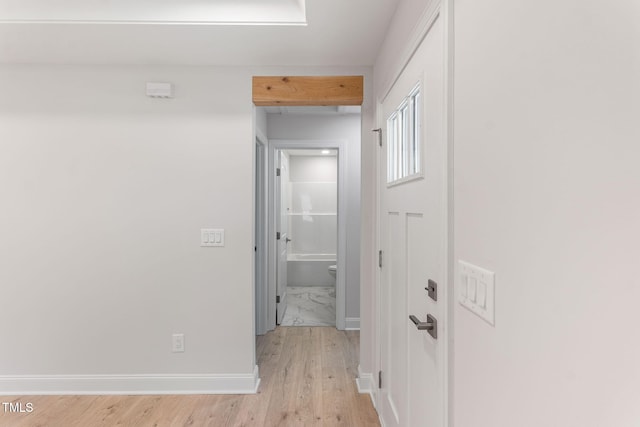 hallway with light hardwood / wood-style floors