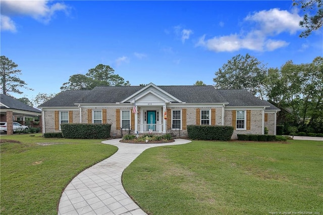 view of front of house featuring a front lawn and brick siding