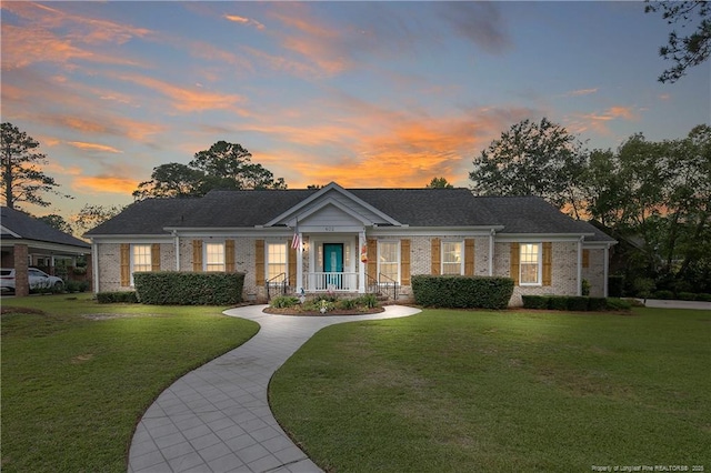 view of front facade with a front lawn and brick siding