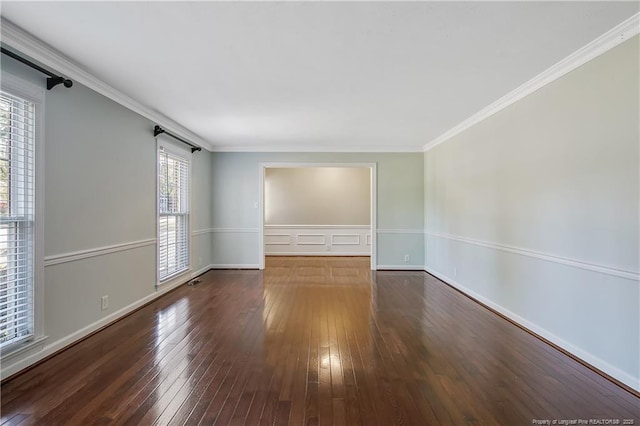 unfurnished room with ornamental molding, dark wood finished floors, and baseboards