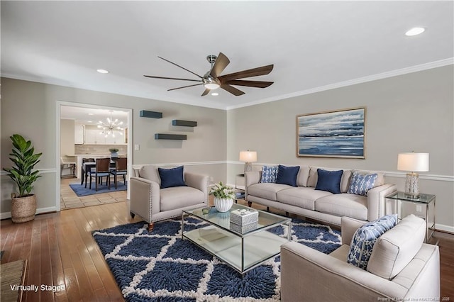 living area with recessed lighting, crown molding, wood finished floors, and ceiling fan with notable chandelier