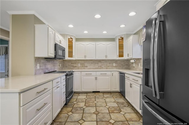 kitchen featuring a peninsula, white cabinetry, light countertops, appliances with stainless steel finishes, and glass insert cabinets