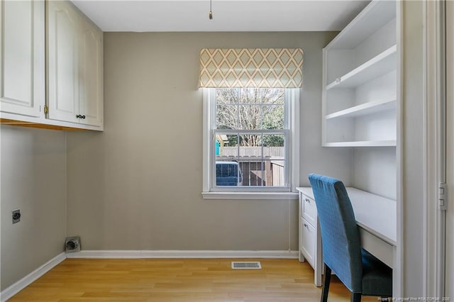 washroom featuring baseboards, visible vents, light wood-style flooring, and hookup for an electric dryer