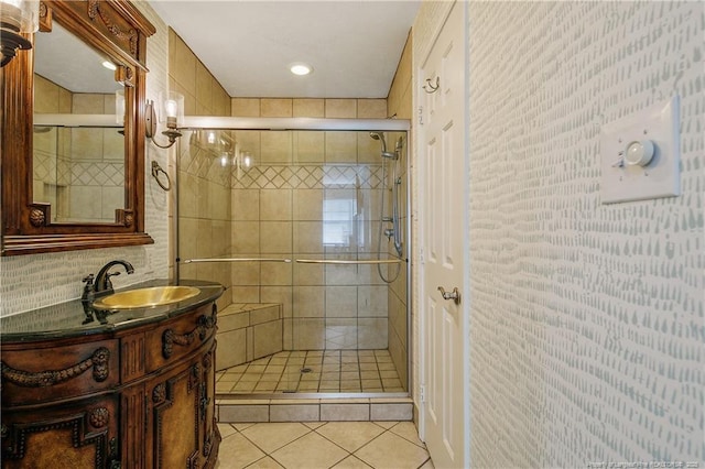 bathroom with a stall shower, tile patterned flooring, and vanity