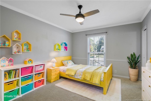 bedroom featuring light carpet, ceiling fan, baseboards, and crown molding