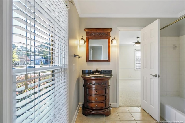 bathroom featuring tile patterned flooring, baseboards, crown molding, and vanity