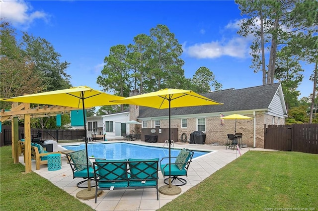 view of pool with a fenced in pool, fence, a lawn, and area for grilling