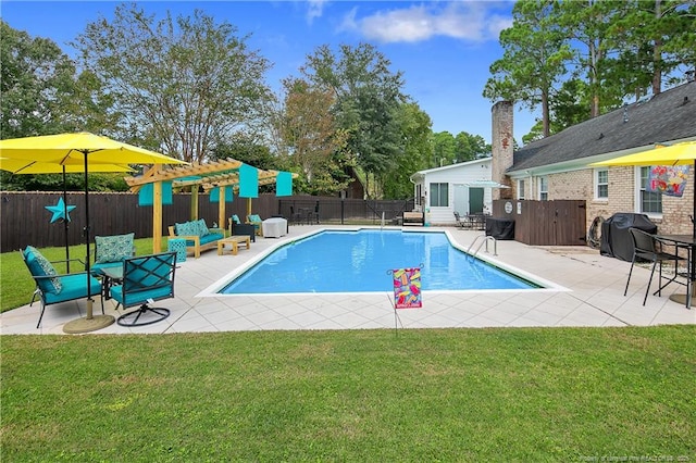 view of swimming pool with a yard, area for grilling, and fence