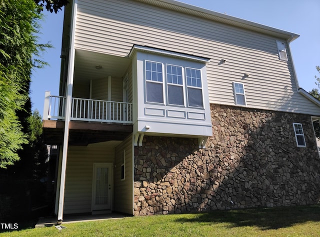 back of house featuring a balcony