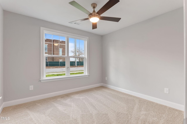 carpeted empty room featuring ceiling fan