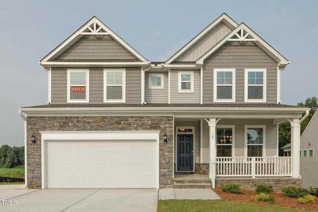 craftsman-style home featuring a garage and a porch