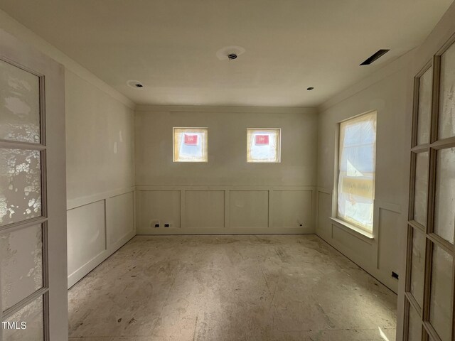 empty room featuring ornamental molding