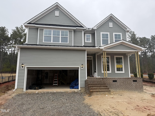 view of front of home featuring a porch and a garage