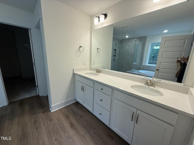 bathroom with independent shower and bath, vanity, and hardwood / wood-style floors