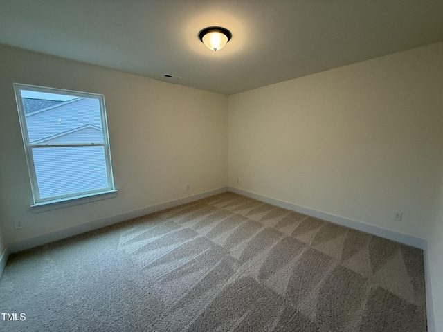 spare room featuring carpet