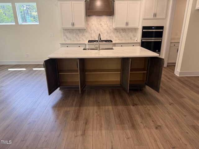 135 Green Haven Blvd Lot # 1, Youngsville, NC 27596 - kitchen featuring premium range hood, open shelves, baseboards, and a sink