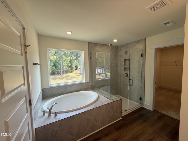 135 Green Haven Blvd Lot # 1, Youngsville, NC 27596 - full bath featuring a garden tub, a shower stall, wood finished floors, a spacious closet, and recessed lighting