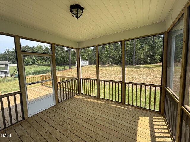 135 Green Haven Blvd Lot # 1, Youngsville, NC 27596 - unfurnished sunroom featuring view of wooded area
