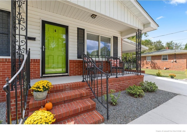 view of exterior entry with a porch