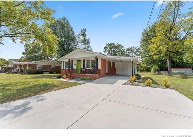 view of front of house with a porch, a front yard, and a carport