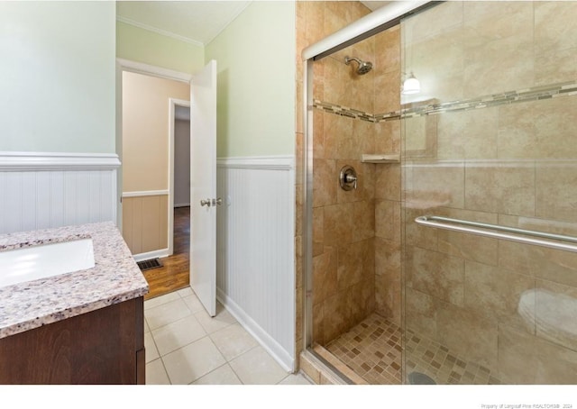 bathroom featuring an enclosed shower, vanity, and tile patterned floors