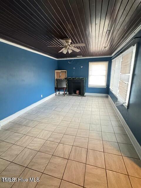 unfurnished living room featuring ceiling fan, crown molding, and wooden ceiling