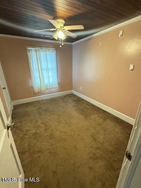 spare room with ceiling fan, crown molding, wooden ceiling, and dark colored carpet