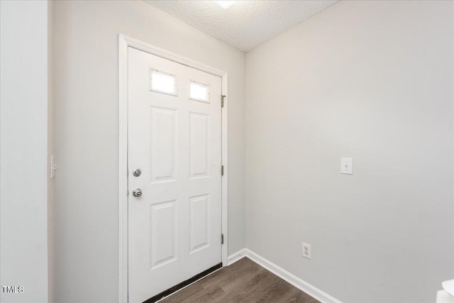 entryway featuring a textured ceiling and dark hardwood / wood-style floors