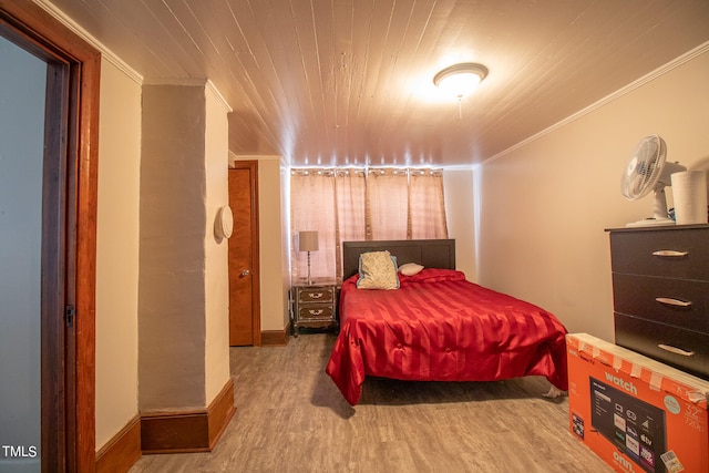 bedroom featuring crown molding, wood ceiling, and hardwood / wood-style flooring