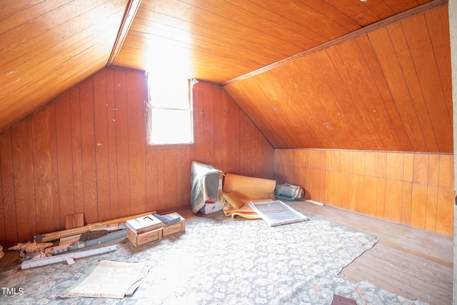 additional living space with hardwood / wood-style flooring, wood ceiling, wood walls, and lofted ceiling