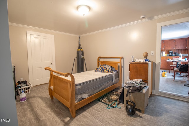 bedroom featuring ornamental molding and dark hardwood / wood-style flooring