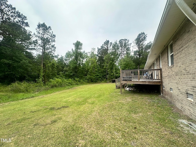 view of yard featuring a wooden deck