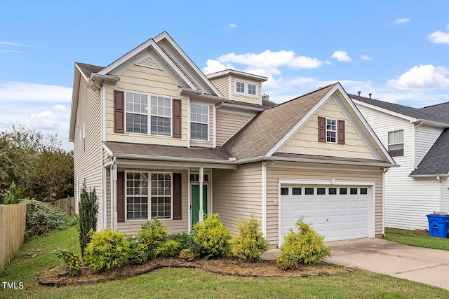 view of front of home featuring a front yard and a garage