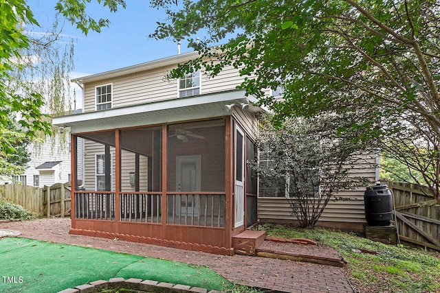 back of house with a sunroom and central AC unit