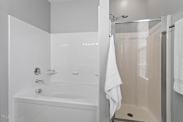 bathroom featuring separate shower and tub