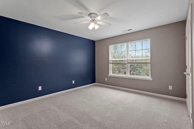 carpeted spare room with ceiling fan