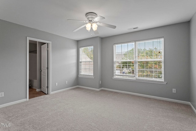 carpeted empty room featuring ceiling fan