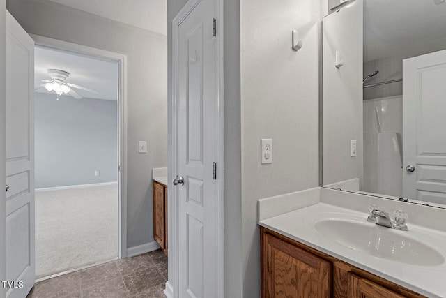 bathroom with vanity, ceiling fan, a shower, and tile patterned flooring