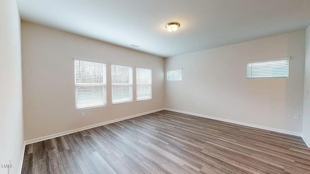 empty room with wood-type flooring