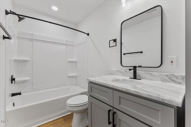 full bathroom featuring vanity, toilet, wood-type flooring, and  shower combination