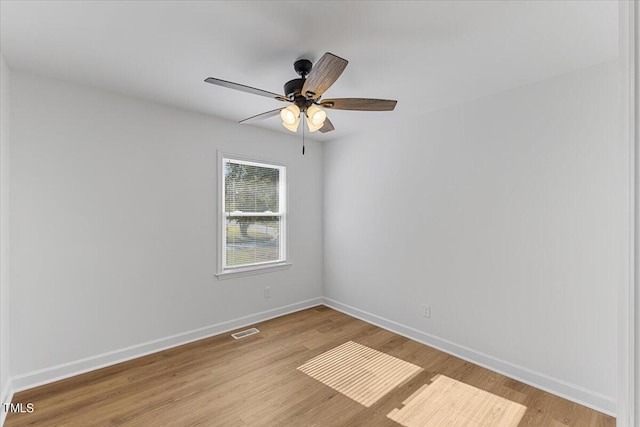 spare room featuring light wood-type flooring and ceiling fan