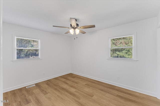 empty room featuring light hardwood / wood-style flooring and ceiling fan